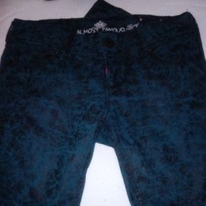 Jeans green with roses all over them.